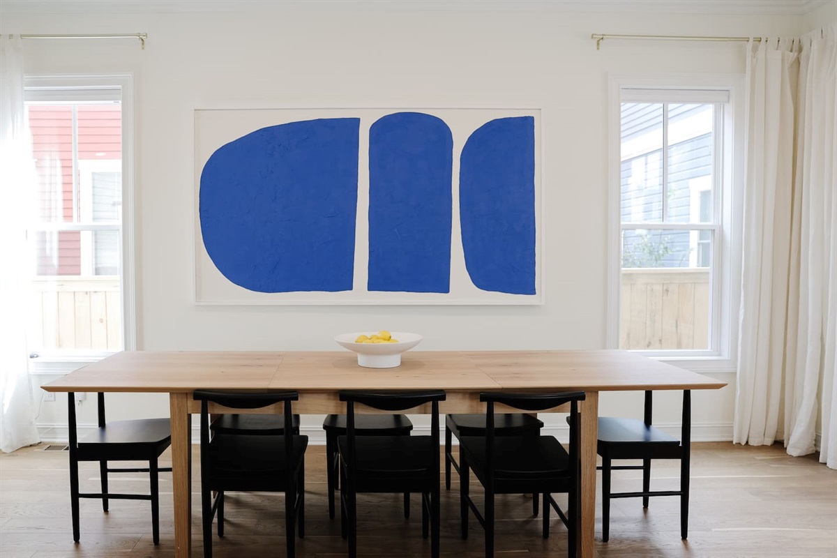 The oversized 8-seat dining table is great for large groups. Featuring custom commissioned art from locals, Modern Coast Co.