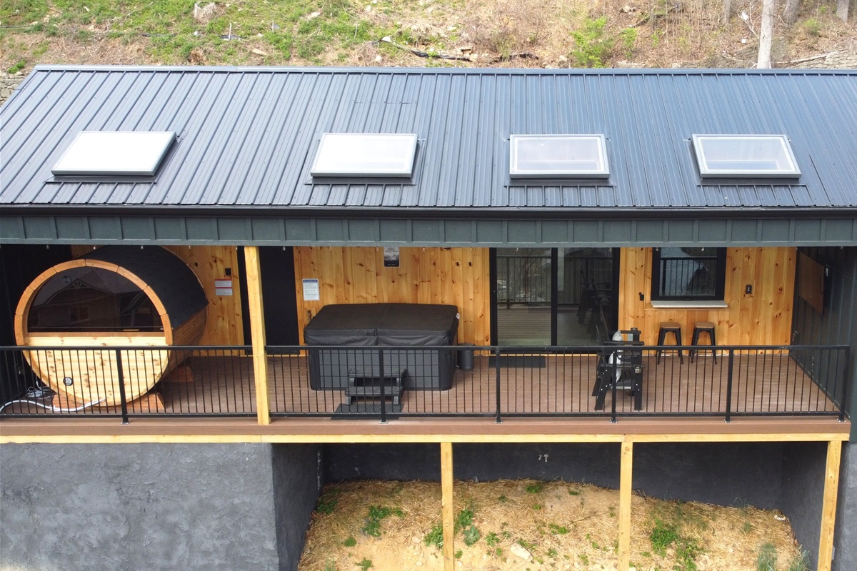 Another view of the expansive back deck with sauna, hot tub, outdoor bar and TV