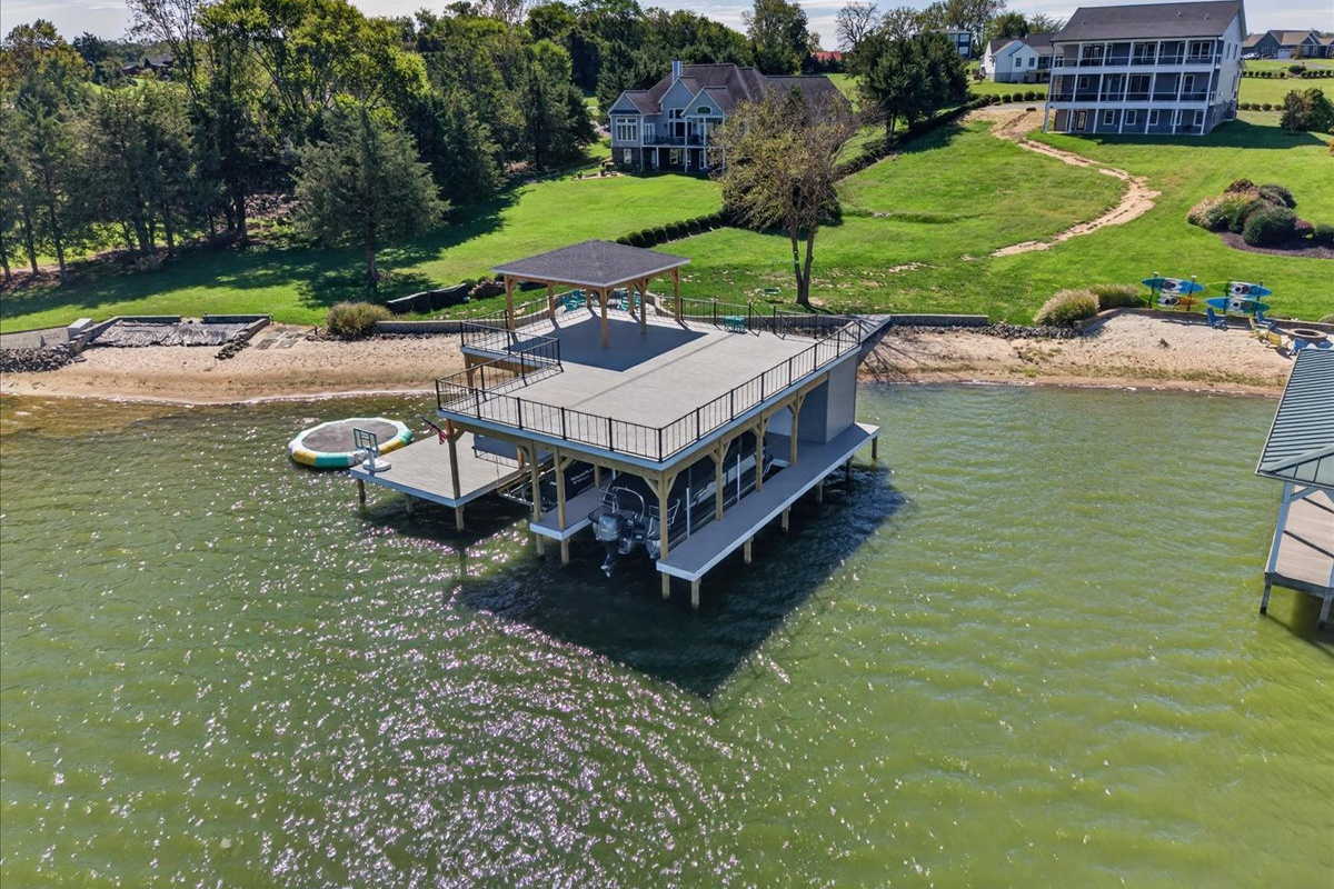 Sweeping aerial view showcasing the expansive waterfront, sandy shoreline, and beautiful Lake Anna surroundings.