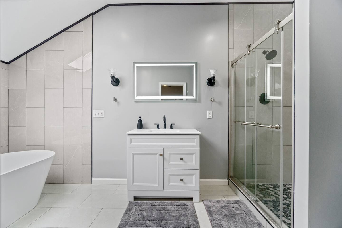 Full bathroom featuring both a bathtub and shower, offering a versatile and relaxing space for ultimate comfort.