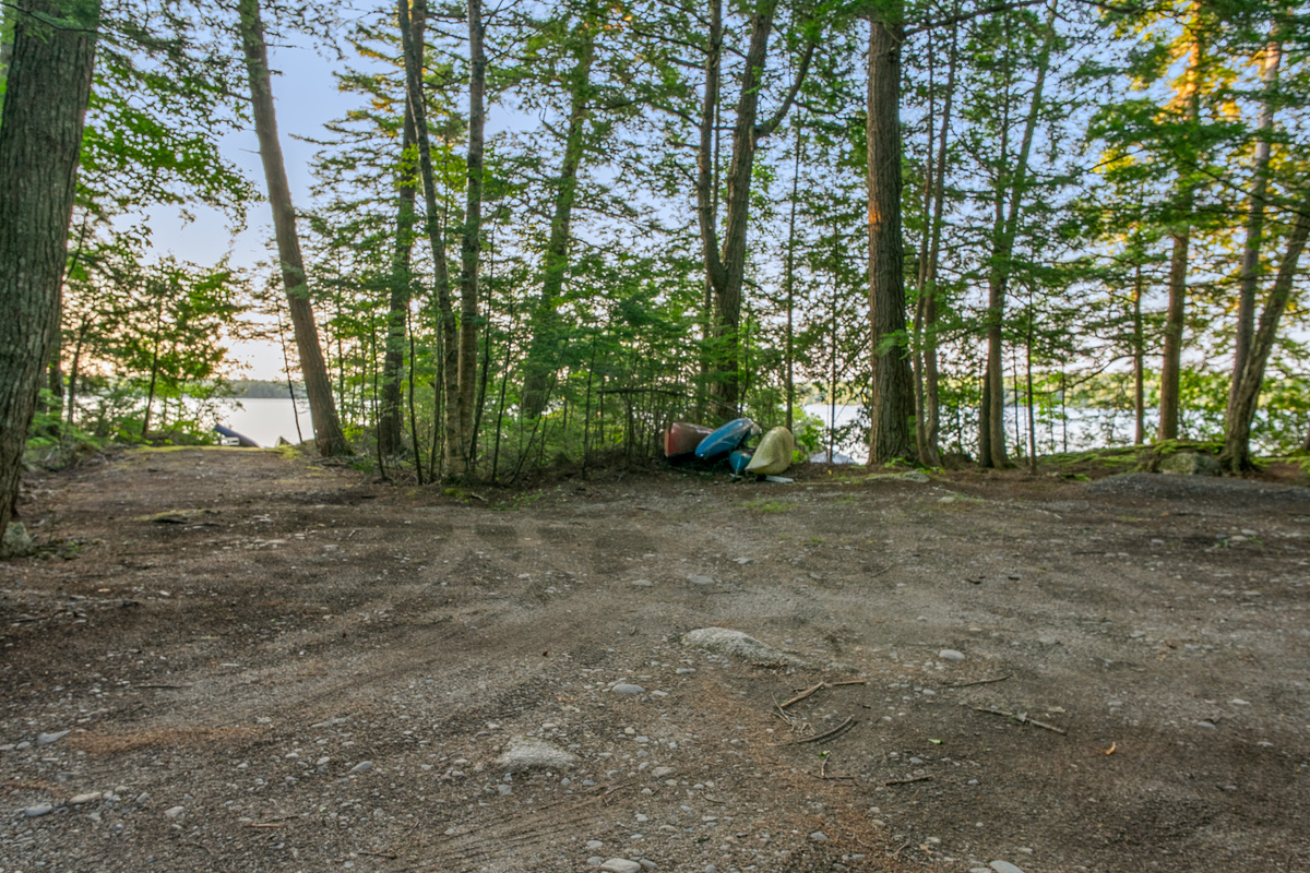 Expanded parking area at Loonrise Point! On-site kayaks and canoe ready to launch. Features a wide, truck-length path down to the beachy water access, ideal for parking boat trailers on Beech Hill Pond in Otis, ME.