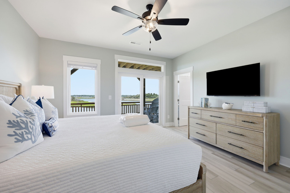 The king primary bedroom opens directly to a private balcony with peaceful sound views