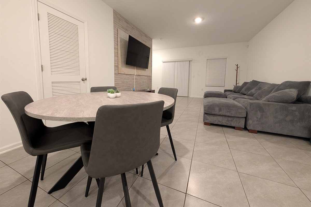 4 place kitchen table with a view of the TV in the background