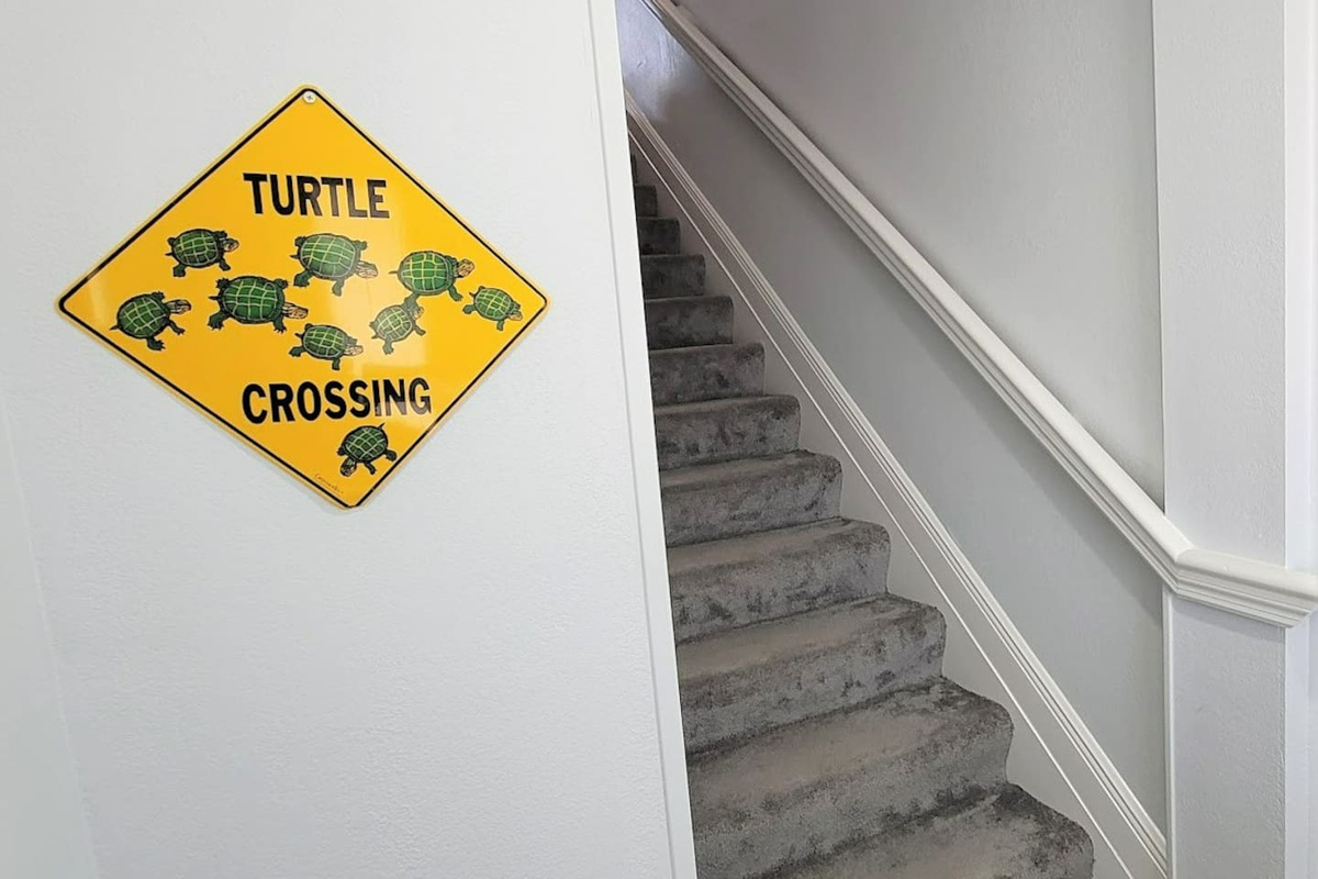 Step through the foyer and head up the carpeted stairs &mdash; the townhome opens above you from the moment you arrive.