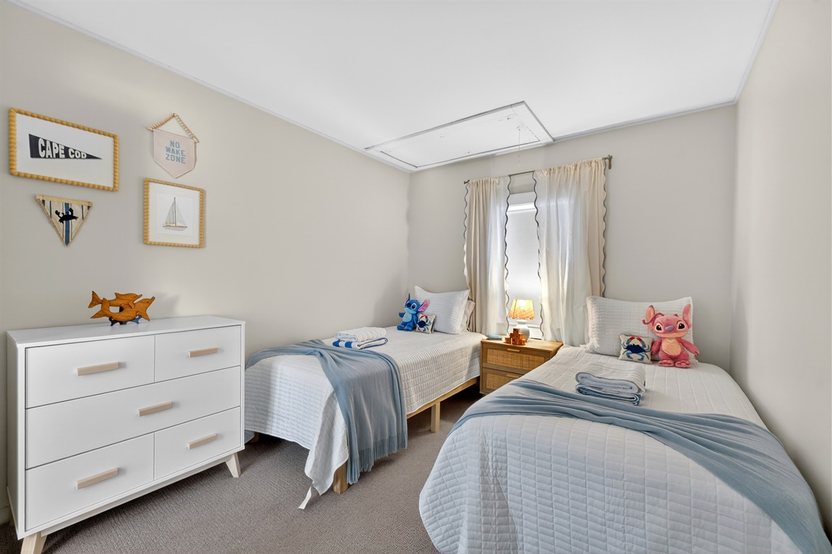 A comfortable bedroom with 2 single beds suitable for those traveling with kids.