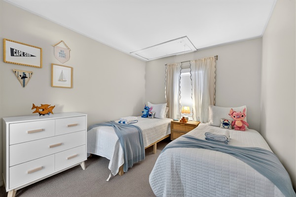 A comfortable bedroom with 2 single beds suitable for those traveling with kids.
