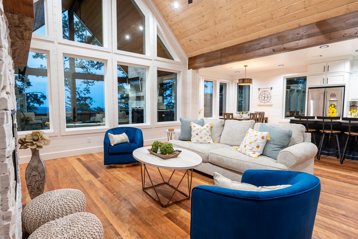 Elegant open-concept lounge with floor-to-ceiling windows and mountain scenery
