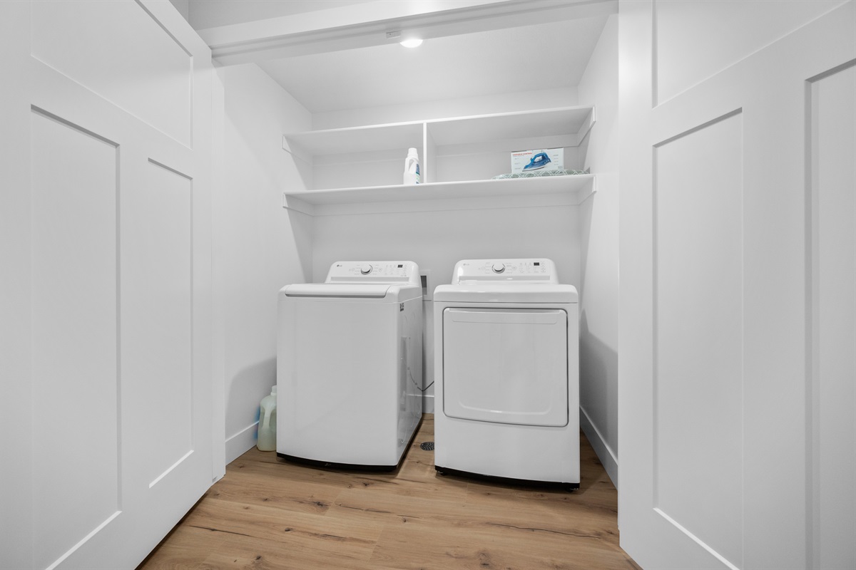 Convenient lower-level laundry room with full-size washer and dryer.