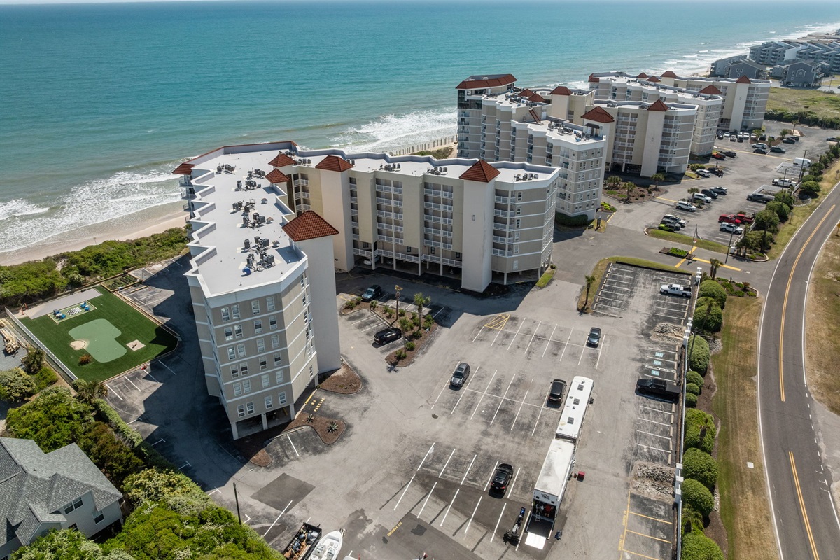 Oceanfront complex with multiple buildings, easy access, and ample parking