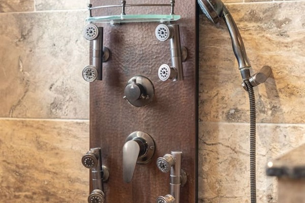 The custom copper shower panel puts a spa at your fingertips — multiple body jets, a handheld wand, and precise controls let you dial in the perfect shower every time.