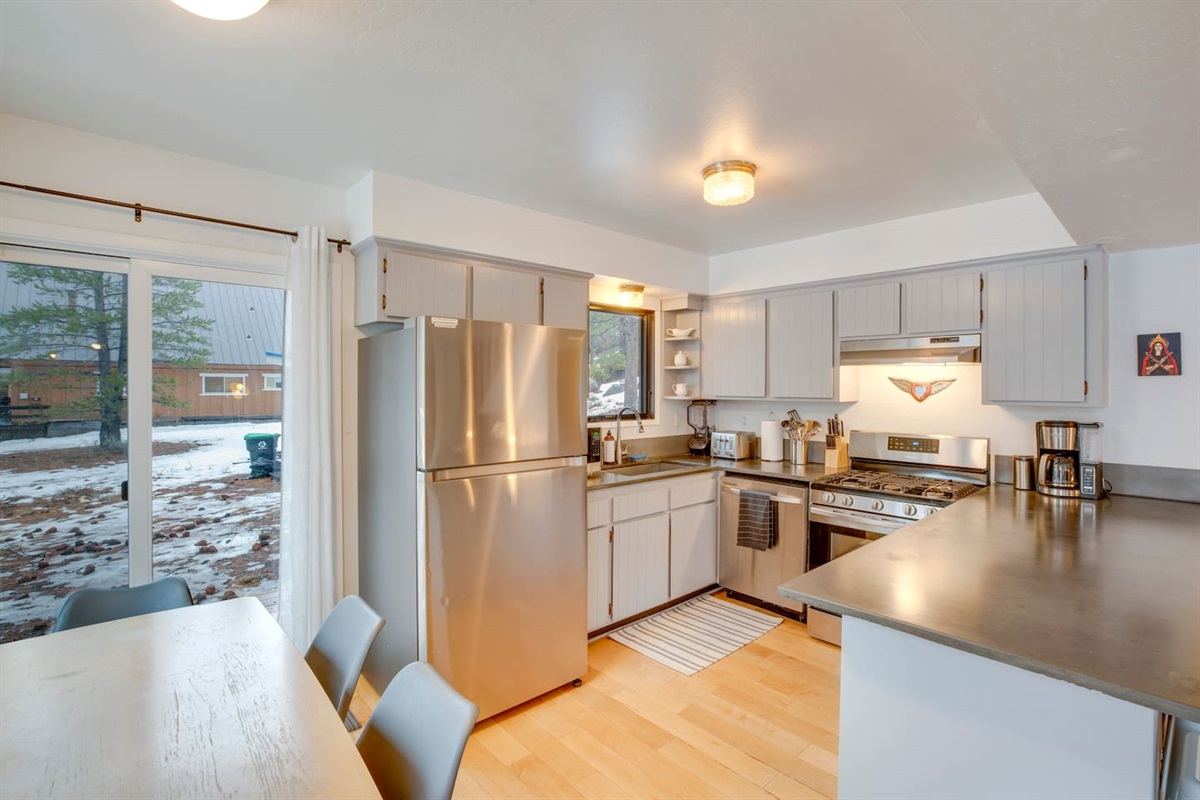 Fully-stocked kitchen with stainless steel appliances.
