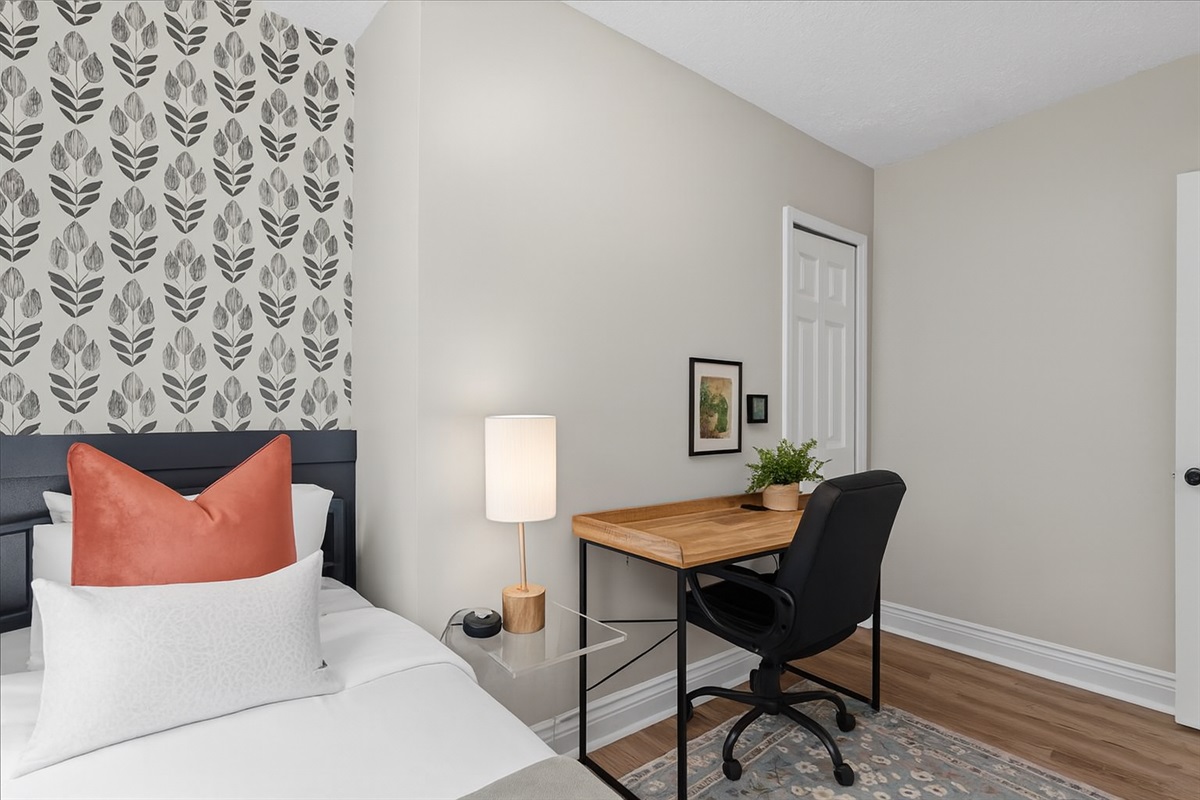 Chic bedroom with stylish accent wall and dedicated workspace