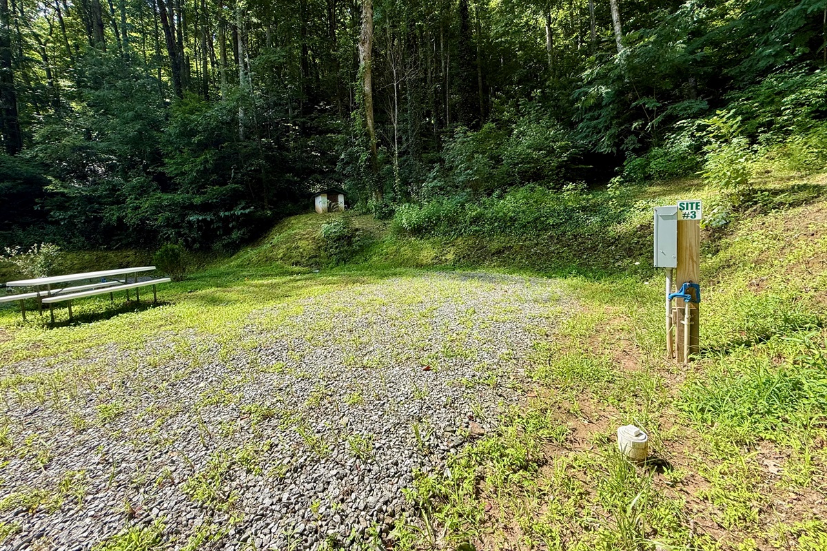 Site 3 at The Cove — 50-amp power, water & sewer hookups, and your own picnic table. Perfect for RVs up to 30 ft.