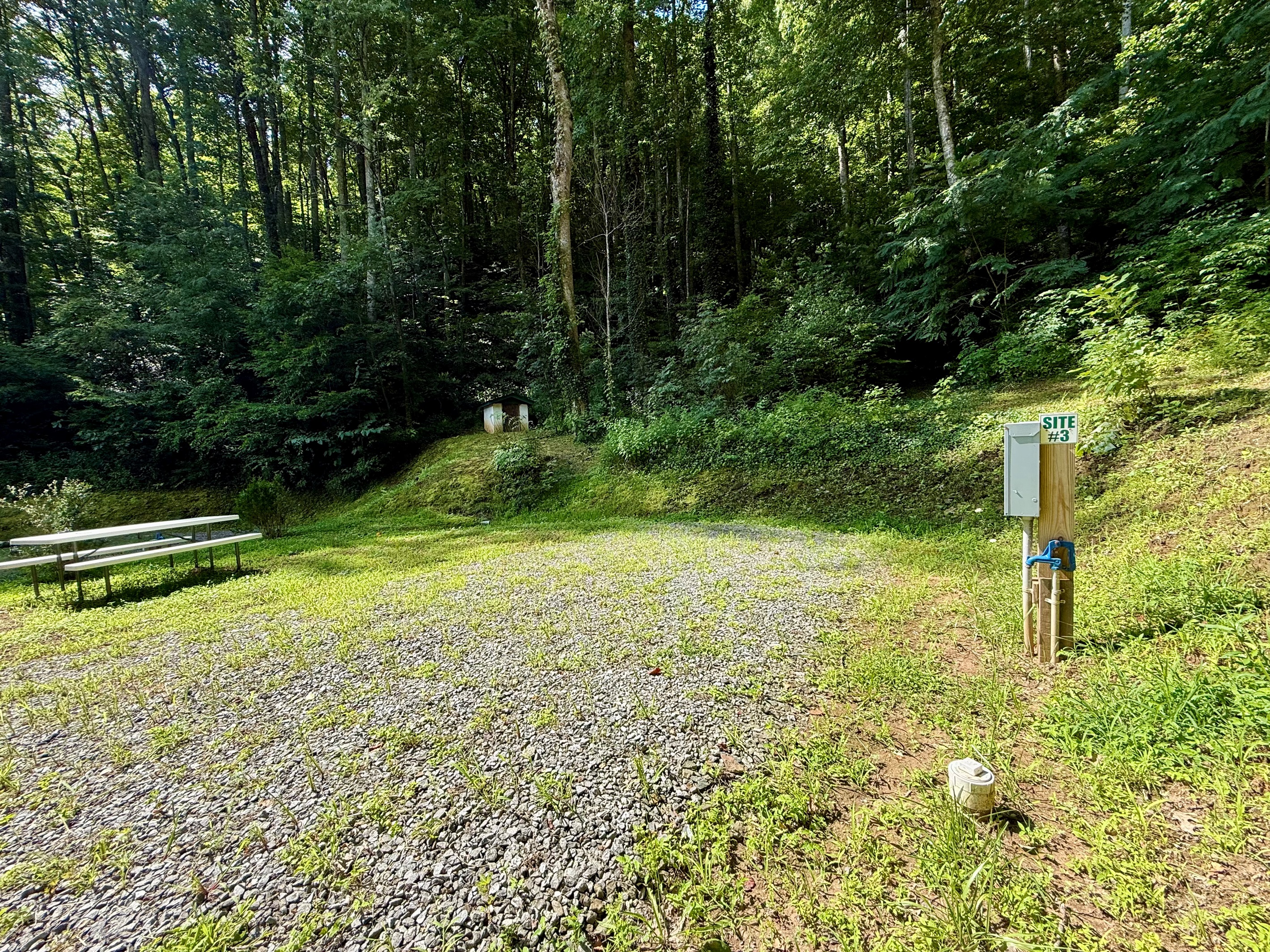 Site 3 at The Cove — 50-amp power, water & sewer hookups, and your own picnic table. Perfect for RVs up to 30 ft.