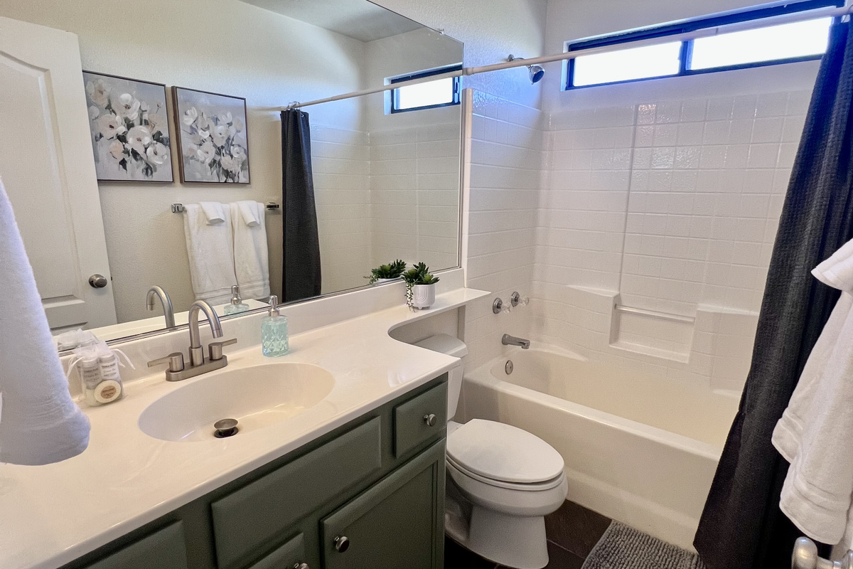 The secondary bathroom features a convenient shower/tub combination and ample counter space, ensuring comfort and functionality for all guests.