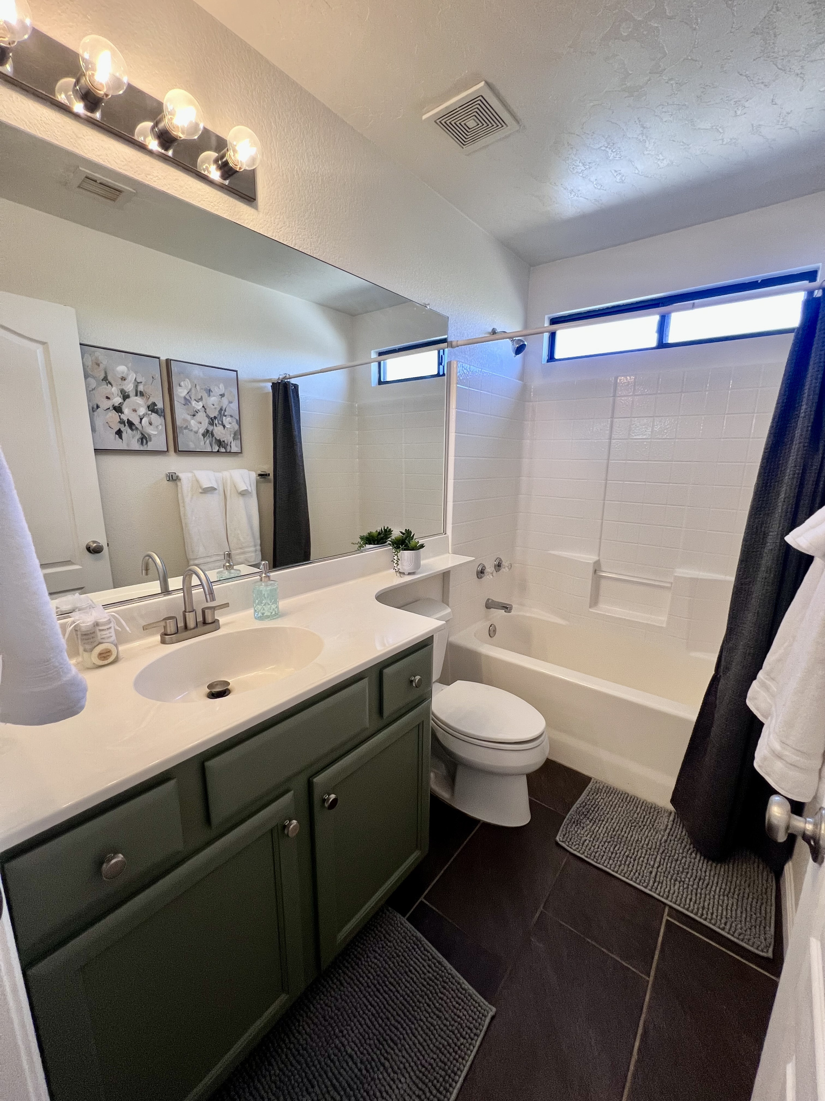 The secondary bathroom features a convenient shower/tub combination and ample counter space, ensuring comfort and functionality for all guests.