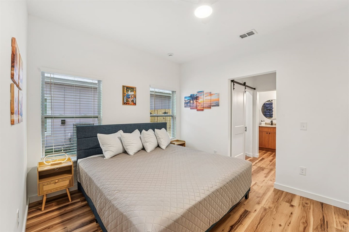 Primary Bedroom has a King size bed, ensuite bathroom with walk-in shower and double vanity, dresser with smart TV on top, lighted mirror, pack n play and air mattress always available inside the closet.