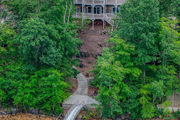 From the water, Sunset Pointe showcases its expansive outdoor living spaces and lakefront charm