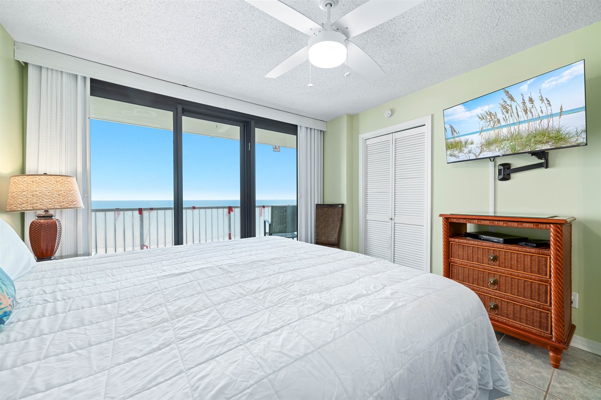 Wake up to stunning Gulf views from this comfortable primary bedroom with king-sized bed and direct balcony access. Perfect for a relaxing vacation.