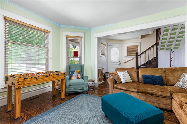 Get cozy in the living room with a plush couch, 75” Smart TV, foosball, and air hockey Everything you need for the ultimate game night and family fun.