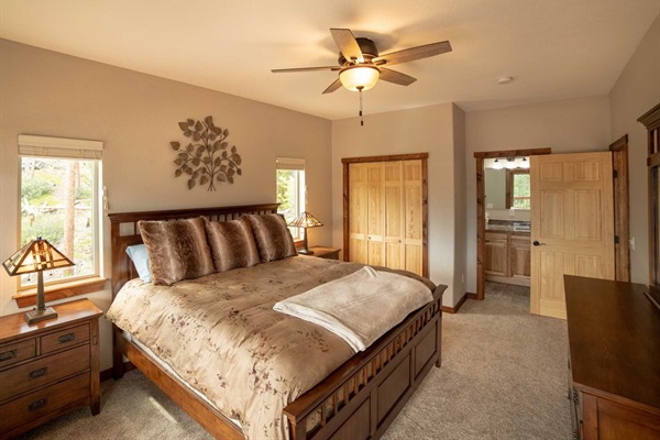 Relax in the main level bedroom featuring a comfortable king bed, stylish furniture, and a Roku Smart TV.
