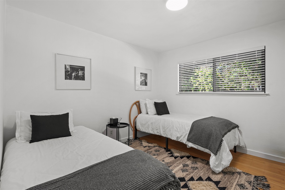 Perfect for kids, friends, or additional guests, this charming bedroom features two twin beds and a comfortable, relaxing setting.