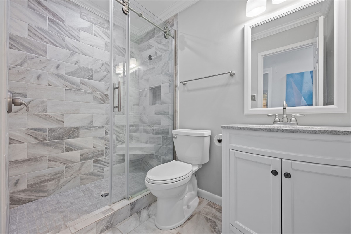 The spacious walk-in shower in this full hall bathroom makes getting ready easy