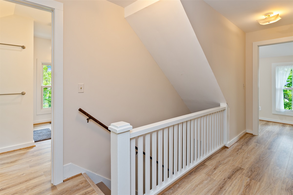 Freshly updated hallway with natural light and modern flooring, leading to bedrooms and baths for easy flow.