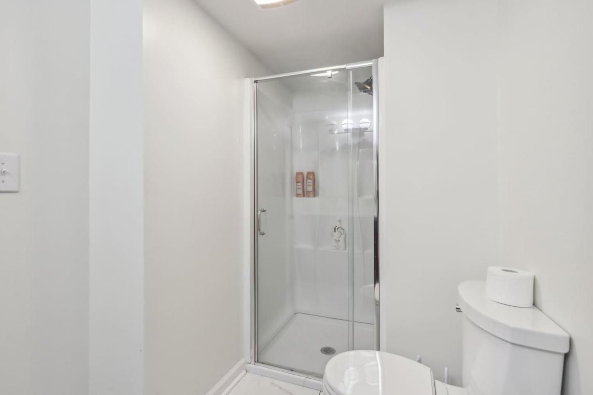Freshen up in full bathroom 3 with a glass-enclosed walk-in shower and a bright, clean layout.