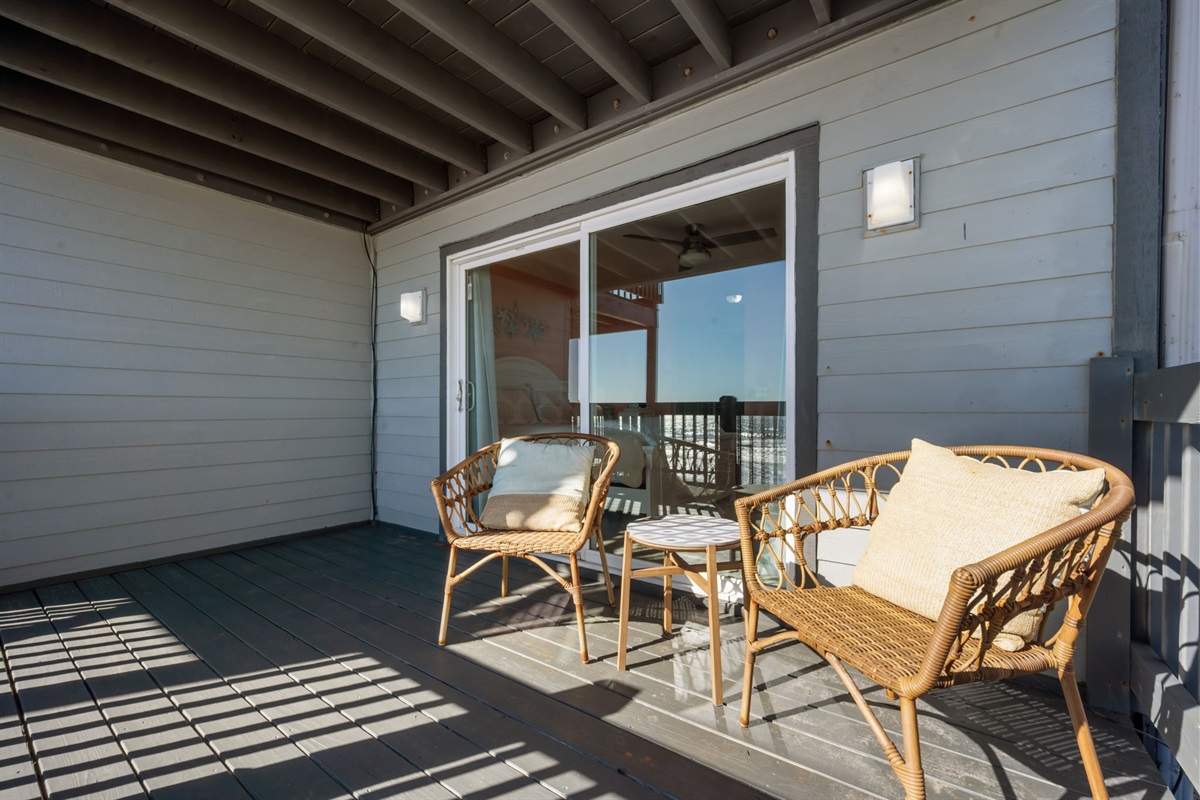 Step outside to your own covered balcony with cozy seating and uninterrupted ocean views