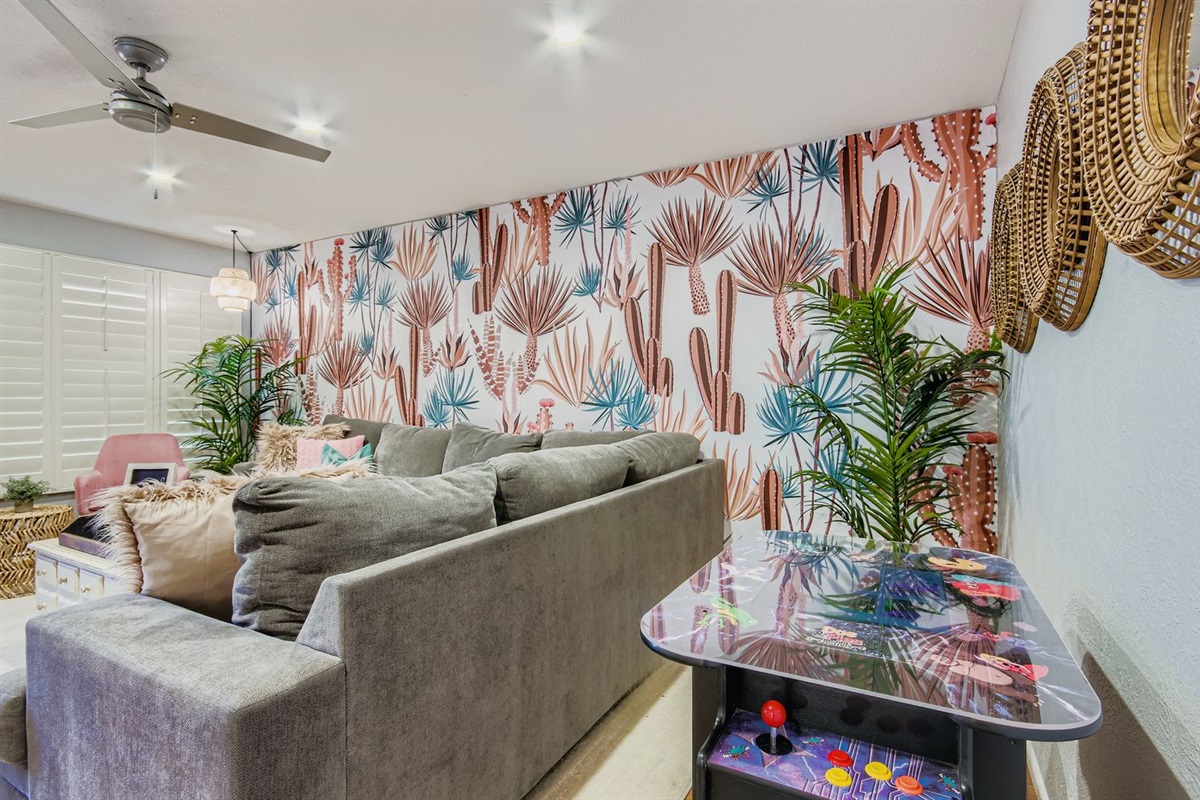 Relax in the living room with a comfy couch and arcade games.