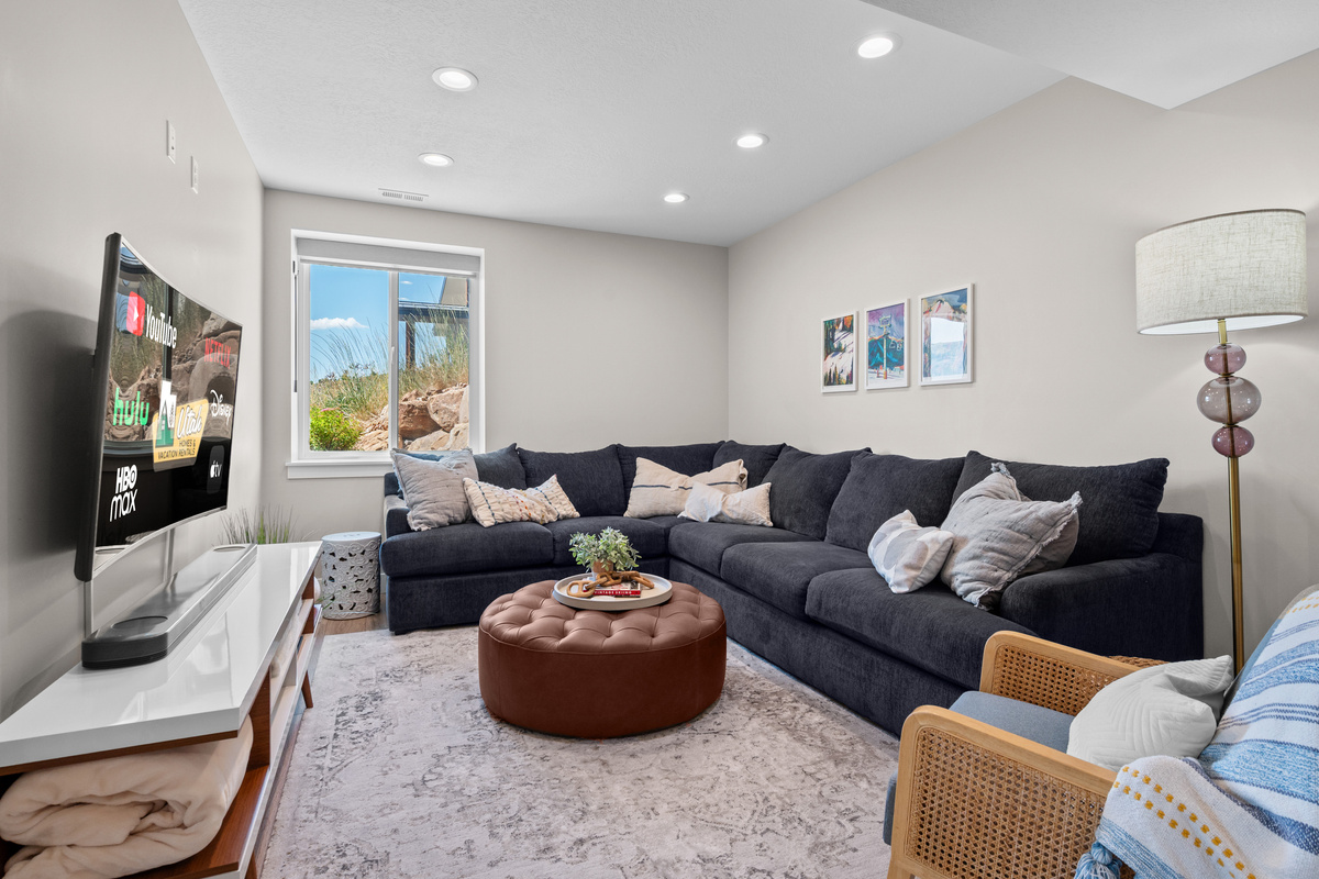 Gather downstairs in the spacious family room featuring comfortable seating, a large Smart TV, and plenty of room to spread out.
