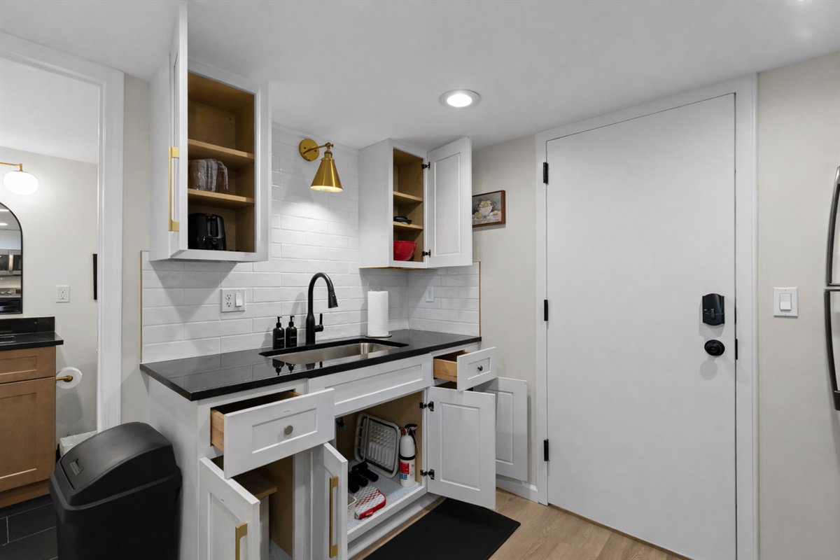 Bright, modern kitchen with sleek countertops, open shelving, quality appliances, and thoughtful storage—fully equipped for everyday cooking.