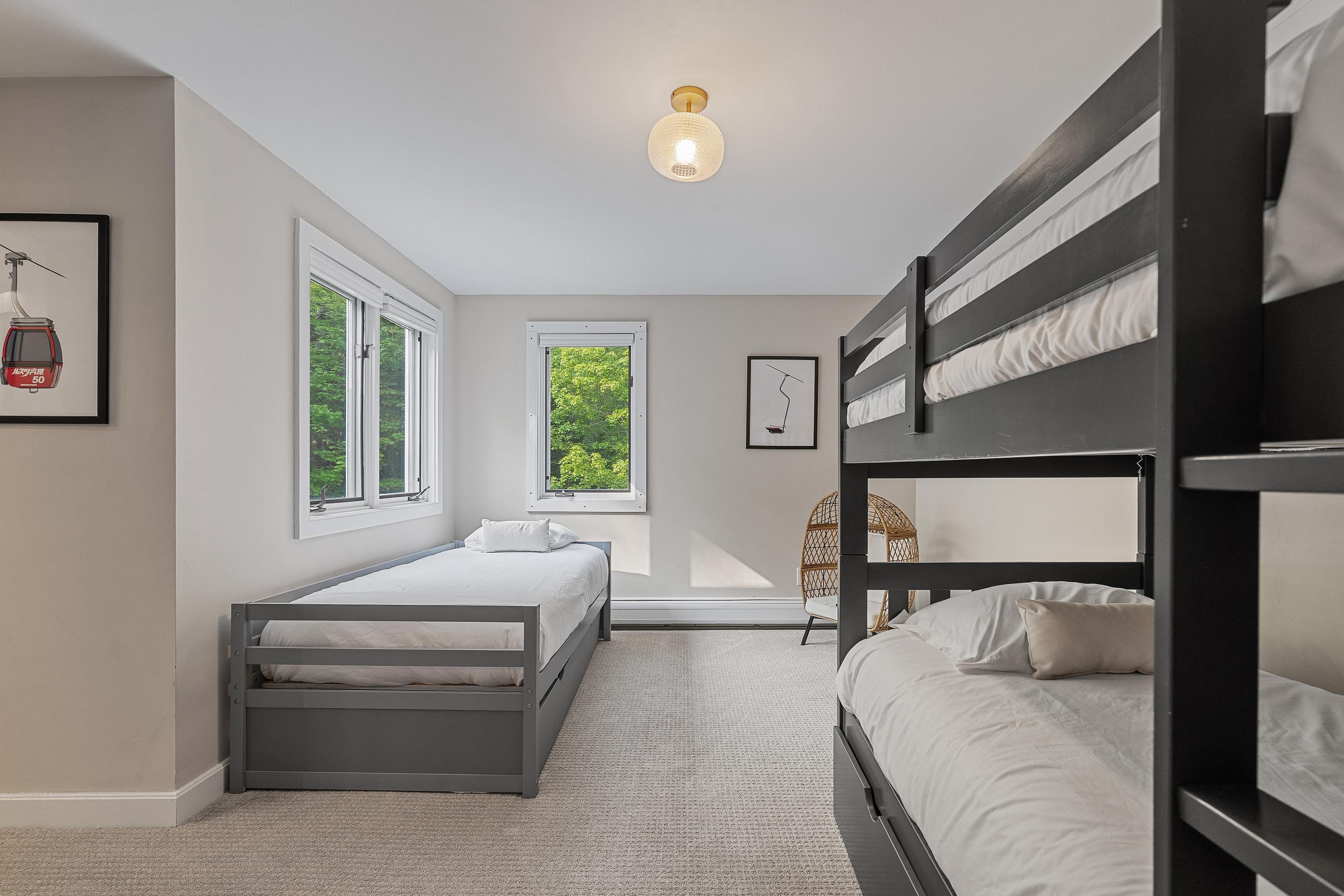 Bunk room with a bunk bed plus a twin bed with a trundle underneath, ideal for kids and larger groups