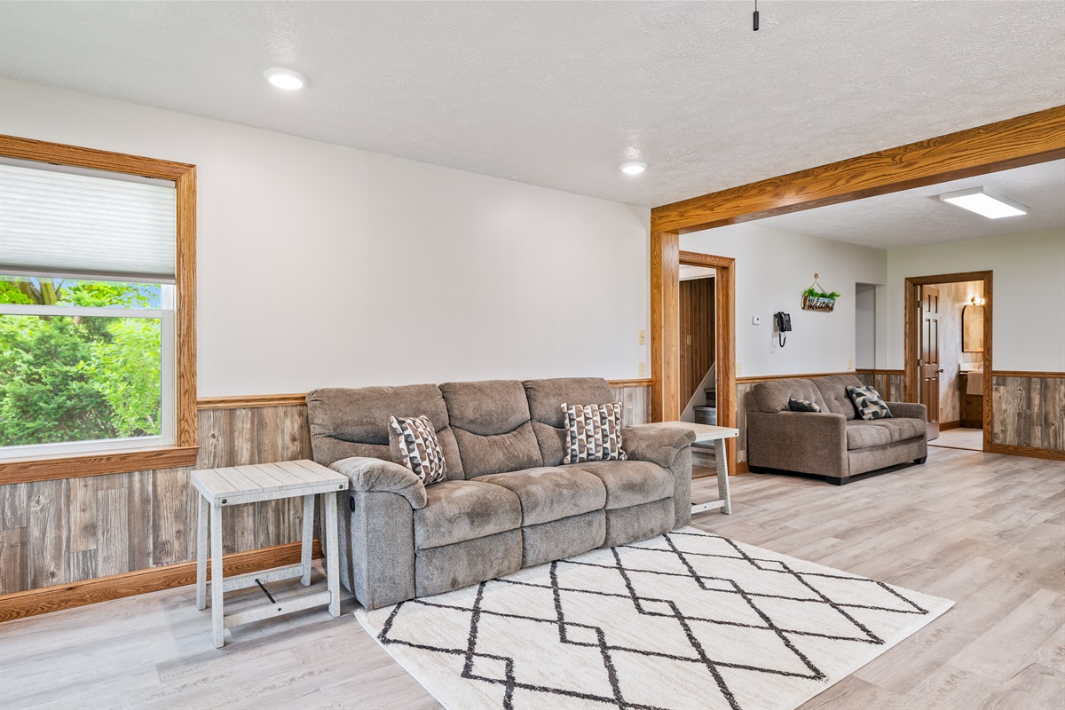 Cozy sitting room with modern wood accents and plush seating—perfect for relaxing after a day of Finger Lakes adventures.