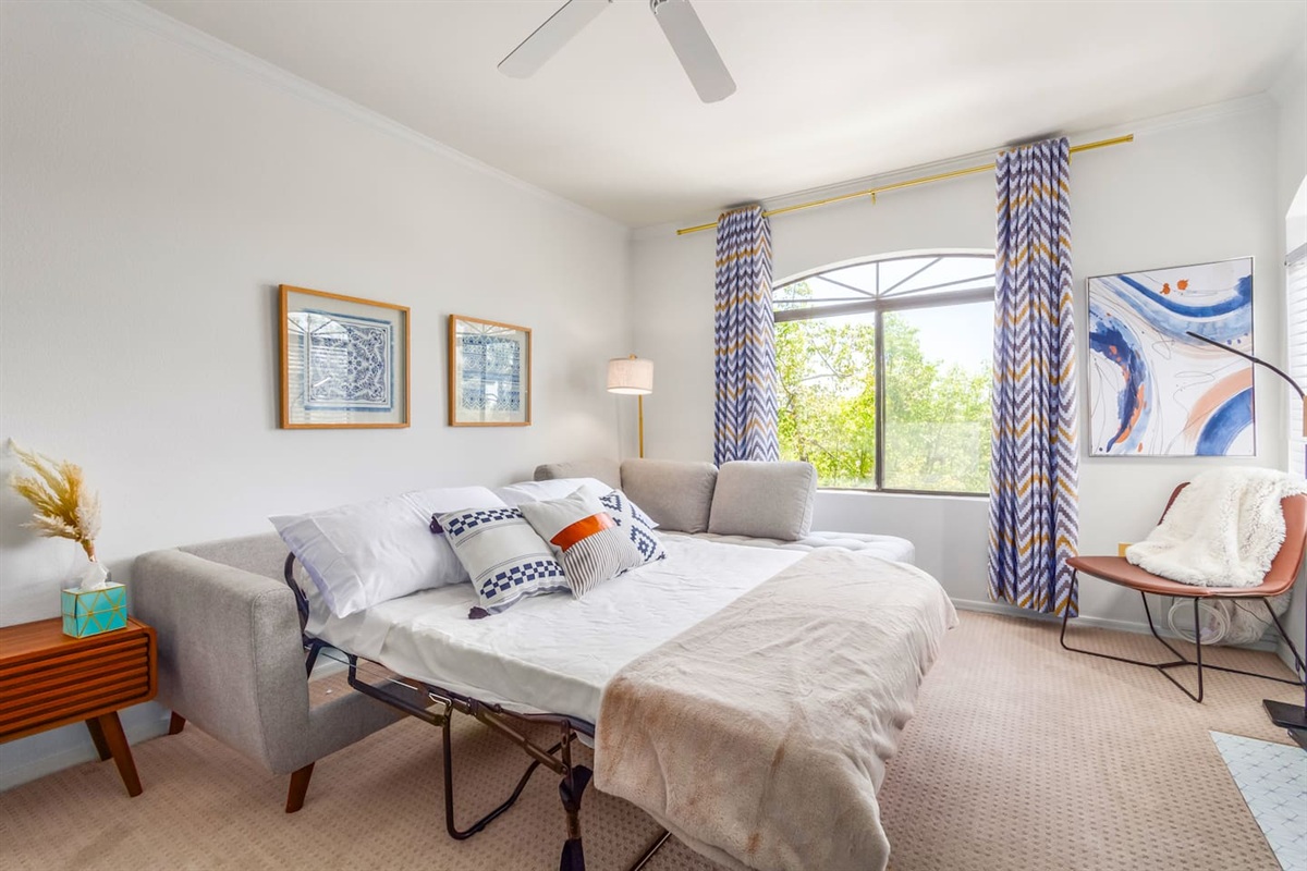 Sleeper sofa setup adds flexible sleeping space while keeping the living room comfortable.