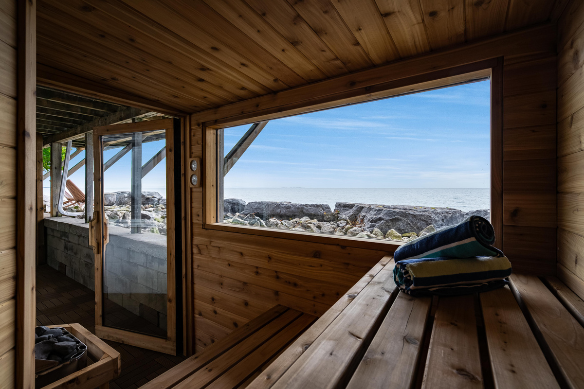 Peaceful sauna retreat with panoramic views of the waterfront.
