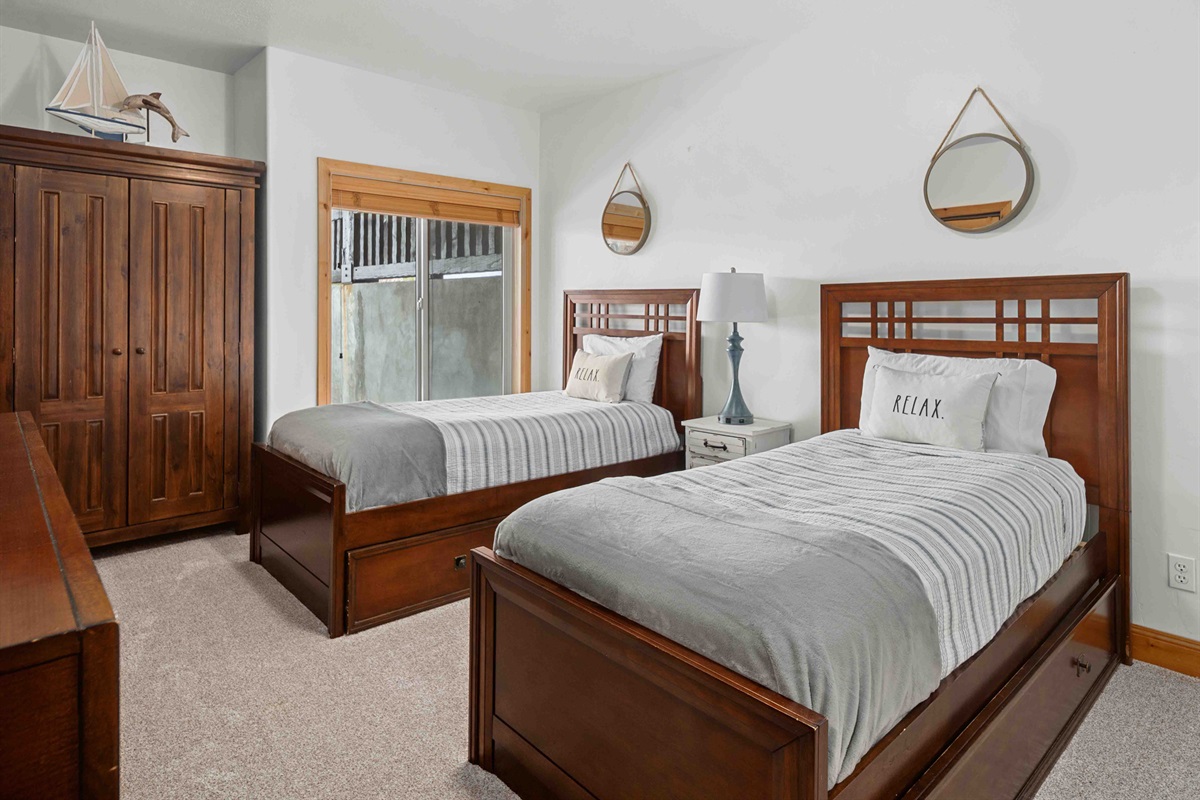 Bedroom with two twin beds with trundles—perfect for kids or additional guests.