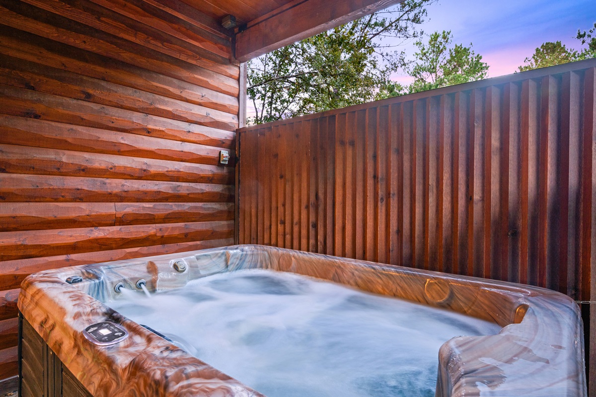 Private hot tub with wood privacy wall for ultimate relaxation.