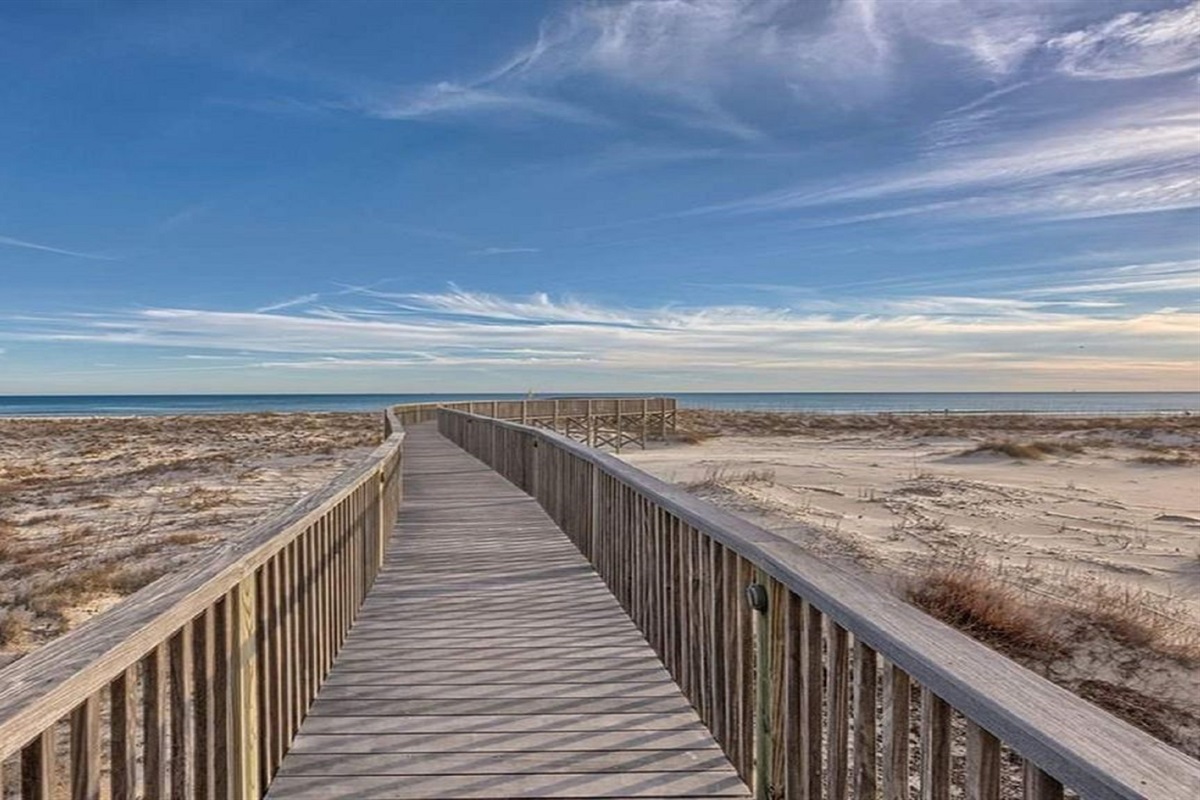 Directly on the sands, this beachfront building offers unparalleled access to the shore and stunning coastal views.