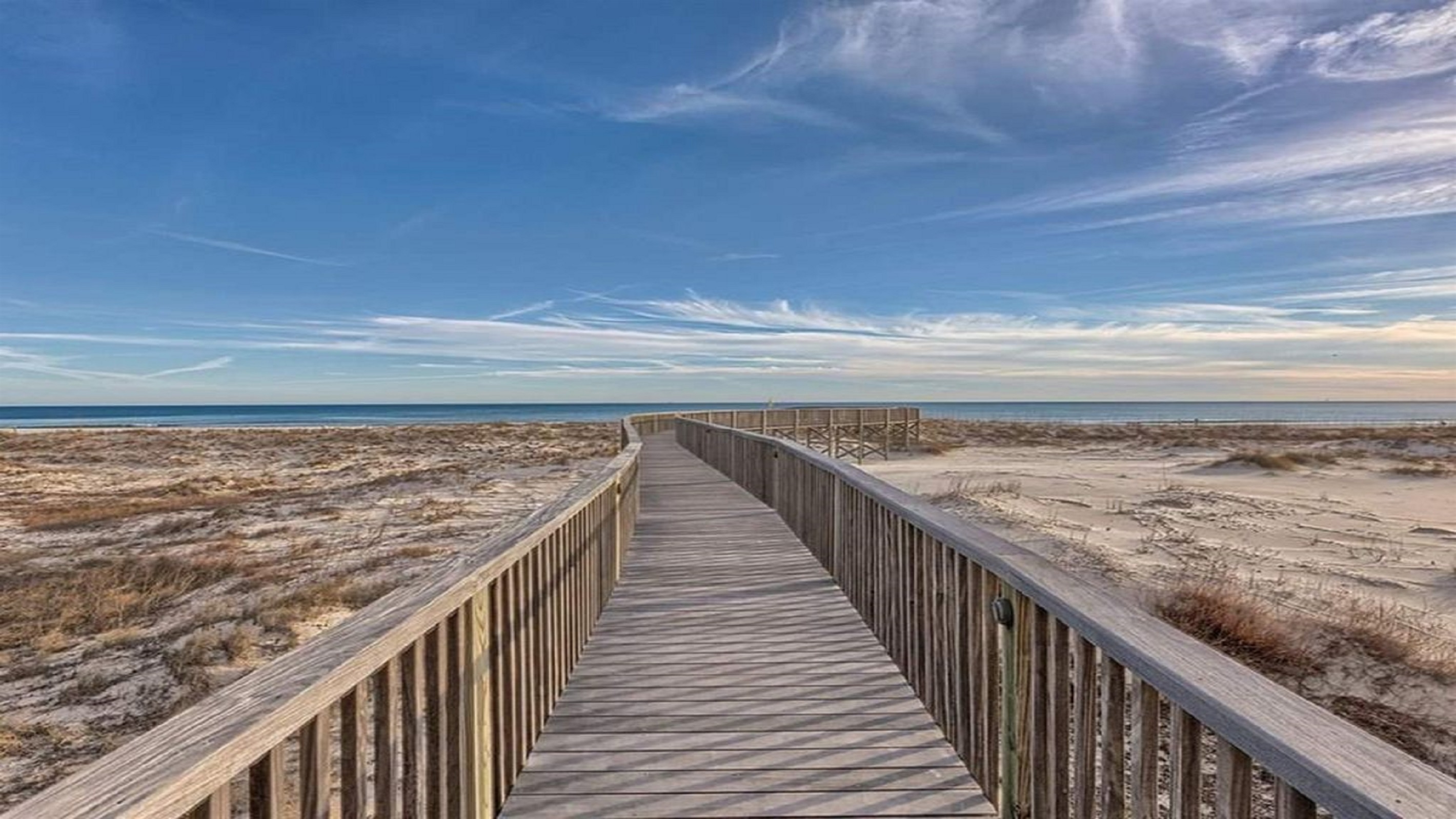 Directly on the sands, this beachfront building offers unparalleled access to the shore and stunning coastal views.