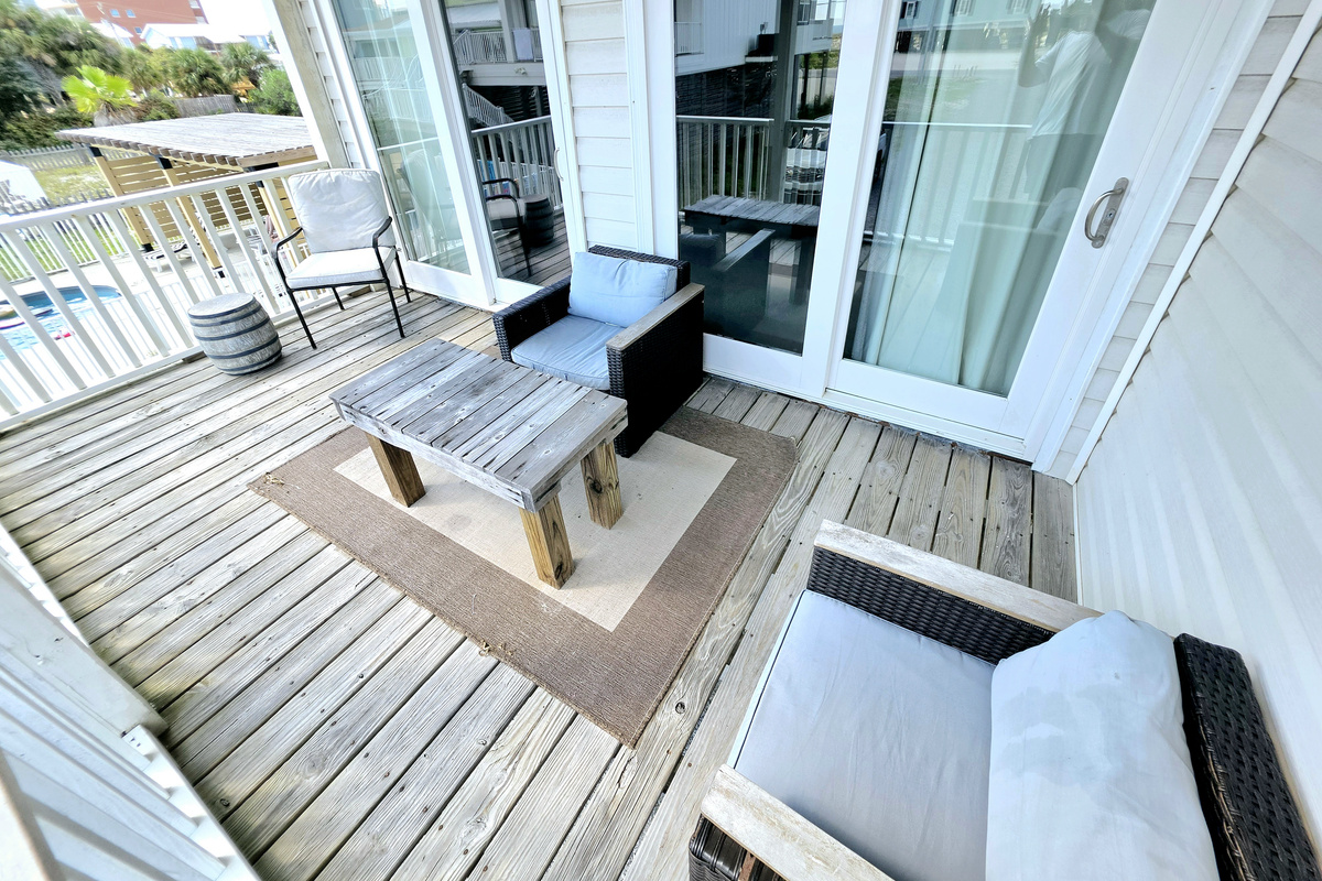 Covered balcony seating just outside the living room