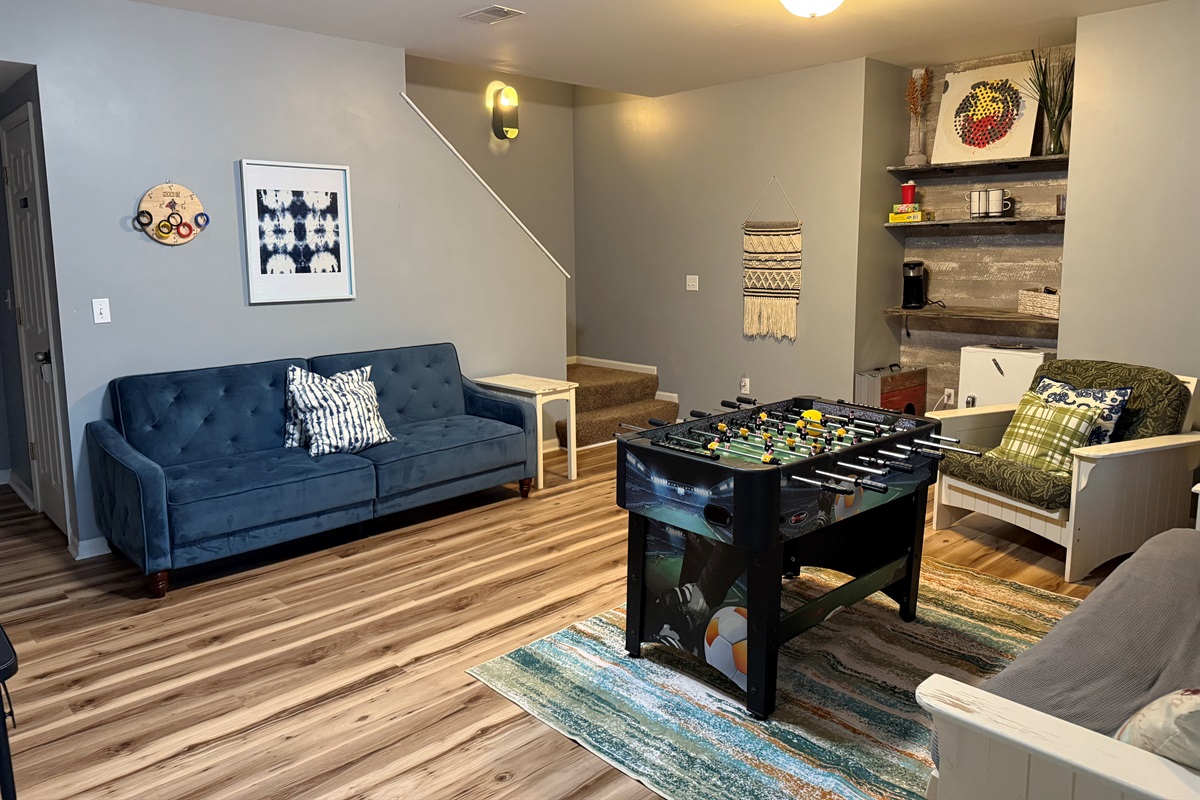 Walkout level living room equipped with smart television, games and foosball table. Walkout the sliders to patio,hot tub, and THE LAKE!