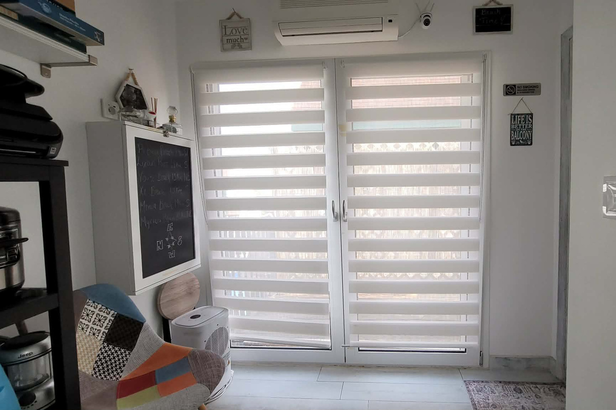 French doors in the common area that lead to a laundry drying rack