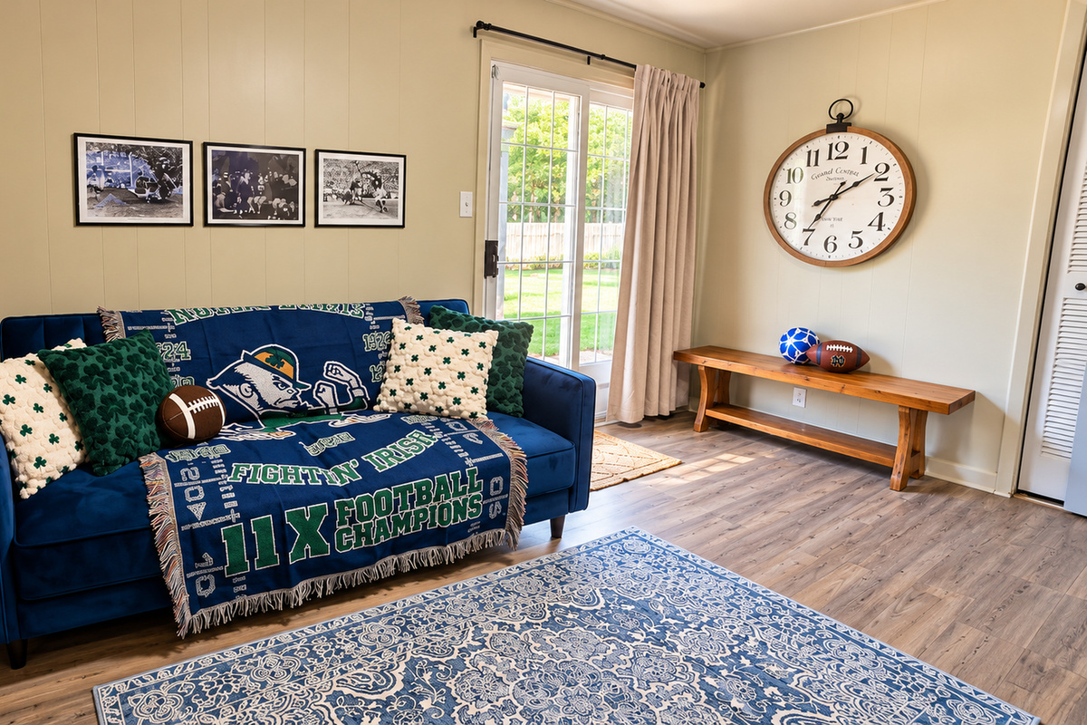 Fighting Irish-inspired den with blue velvet sleeper sofa and backyard access.