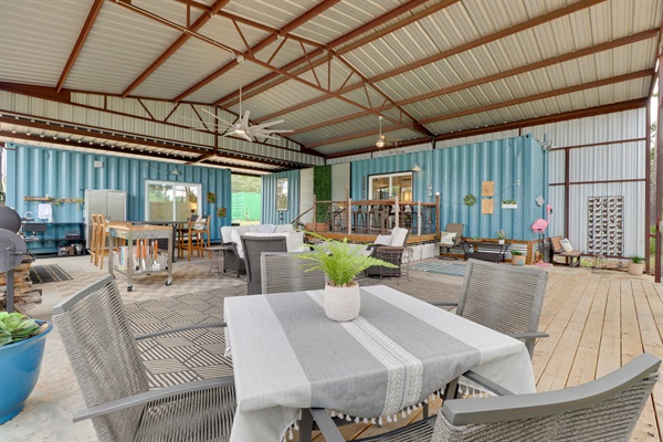 Large covered patio features several eating areas.