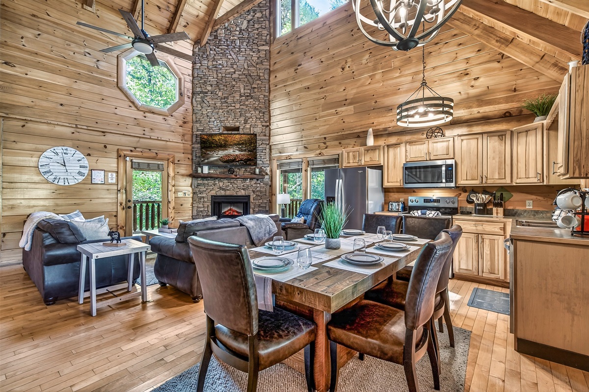 Step into the large open concept kitchen, dining area, and living room with captivating vaulted ceilings.