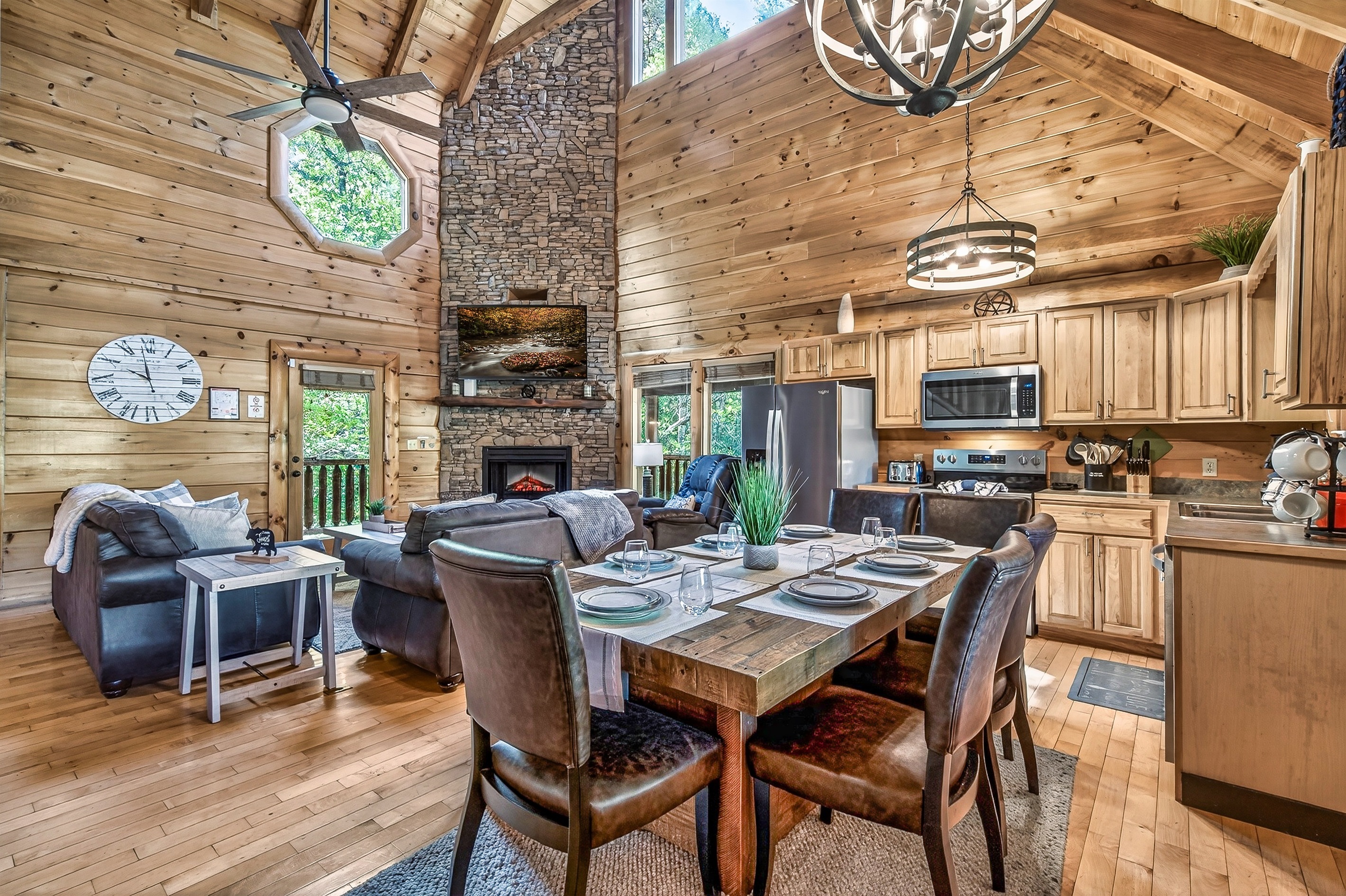Step into the large open concept kitchen, dining area, and living room with captivating vaulted ceilings.