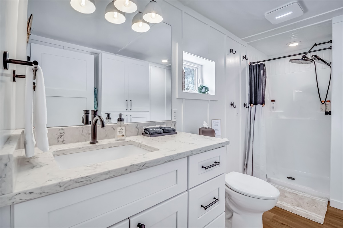 Full bathroom includes soap, shampoo, conditioner, body wash, towels, hand soap, toilet paper, hair dryer