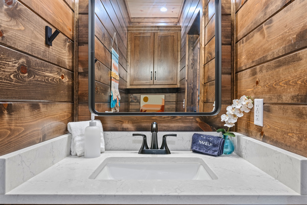 This half bath sink setup is simple, clean, and convenient, with plenty of counter space for washing up and keeping the day moving smoothly.